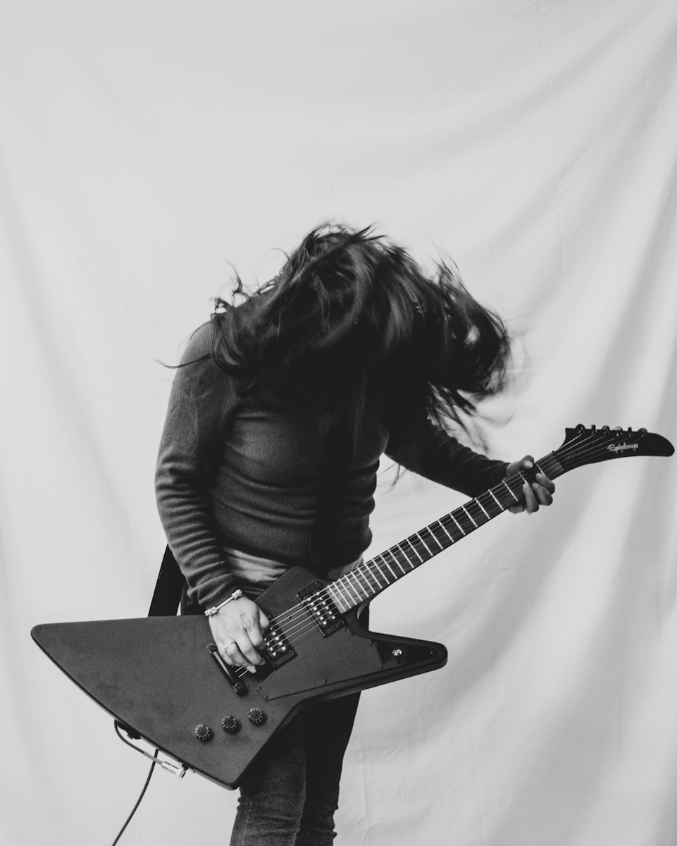 woman playing electric guitar