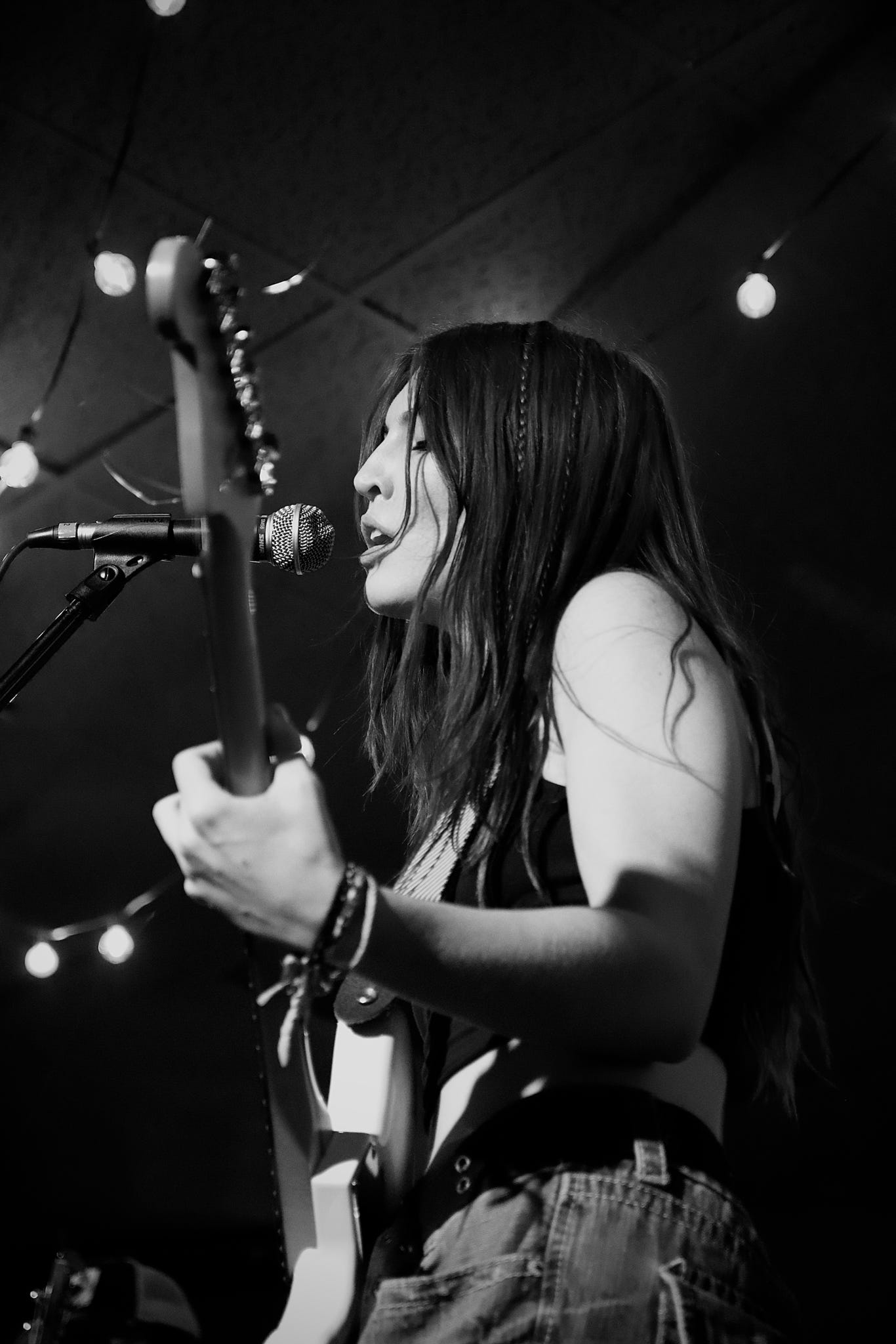 woman playing electric guitar