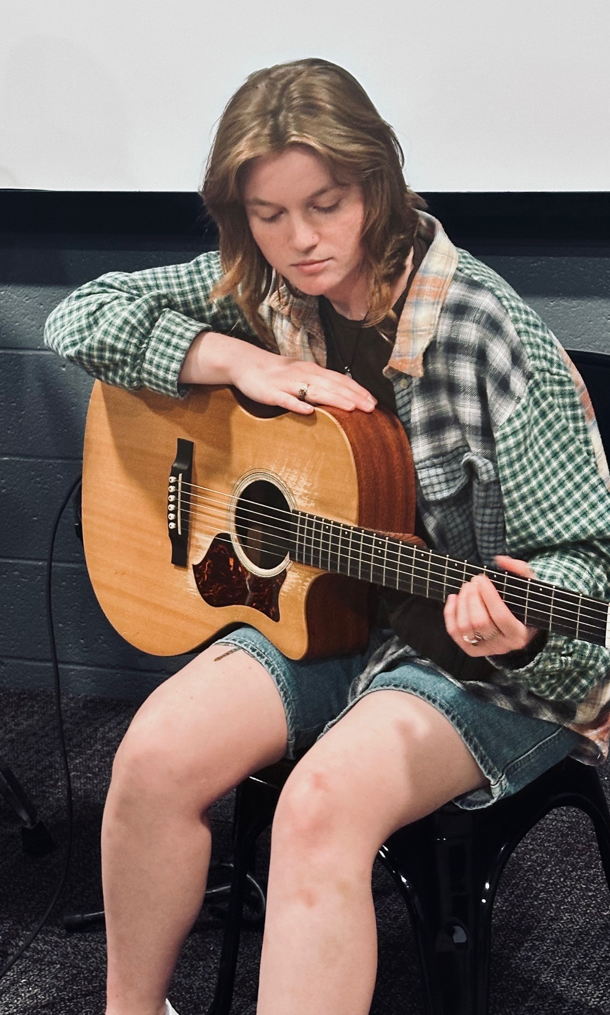 woman playing electric guitar
