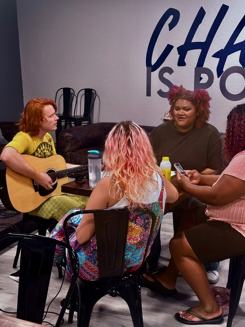 woman playing electric guitar